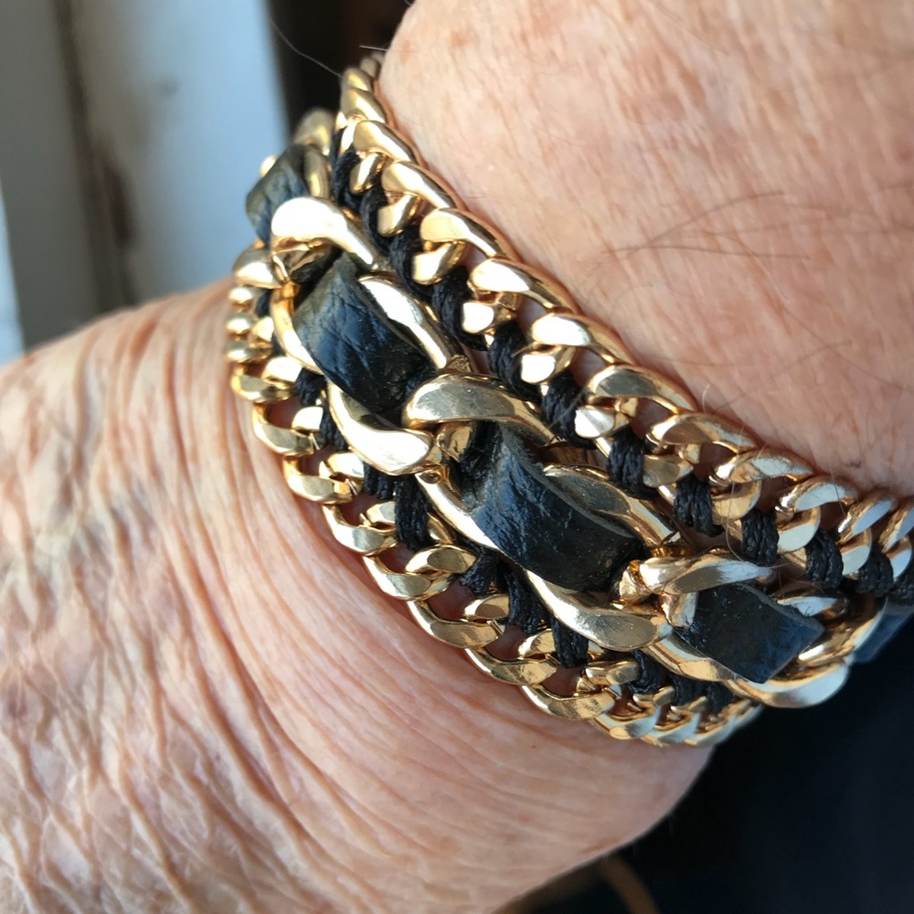 Women’s black and gold leather wrap bracelet.